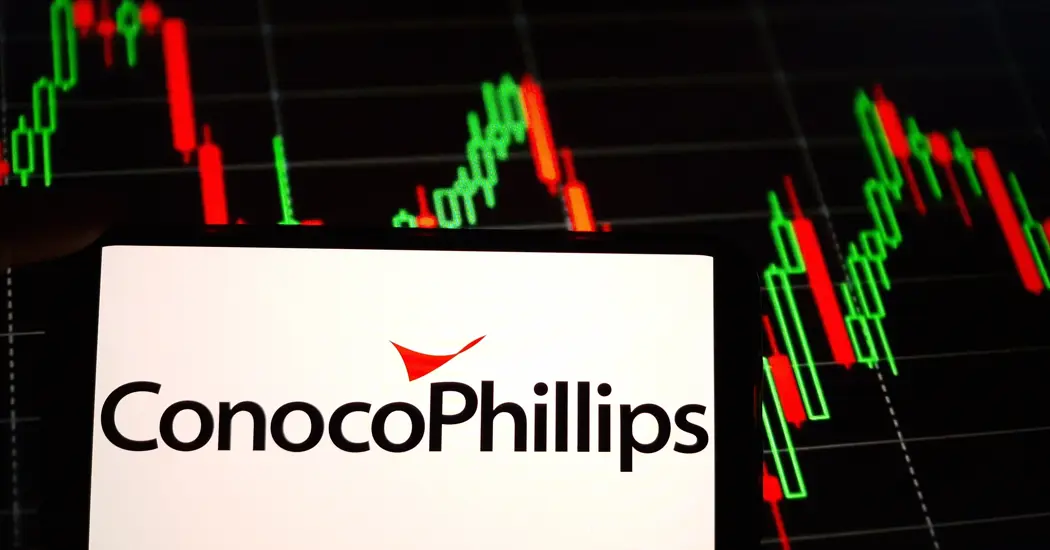 image is Conocophillips logo on a phone screen with data in the background