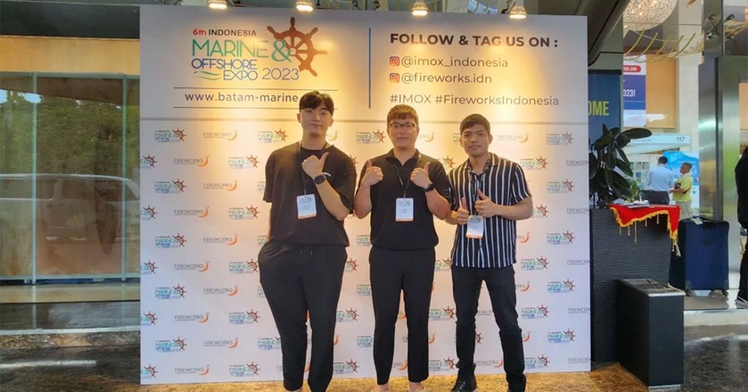 image is Posing at the entrance of the IMOX Exhibit Hall, Radisson Convention Center, Batam, Indonesia from left to right: Jayden Lee (BD Manager), Kayne Kim (COO), and Nico Rivera (Global BD Manager)